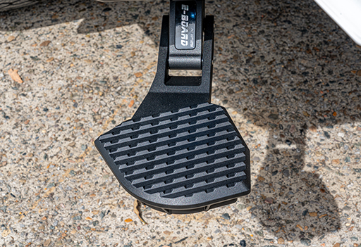 Extreme close-up of the heavy-duty, non-slip tread on the Supreme Electric Rear Step for safe utility access>